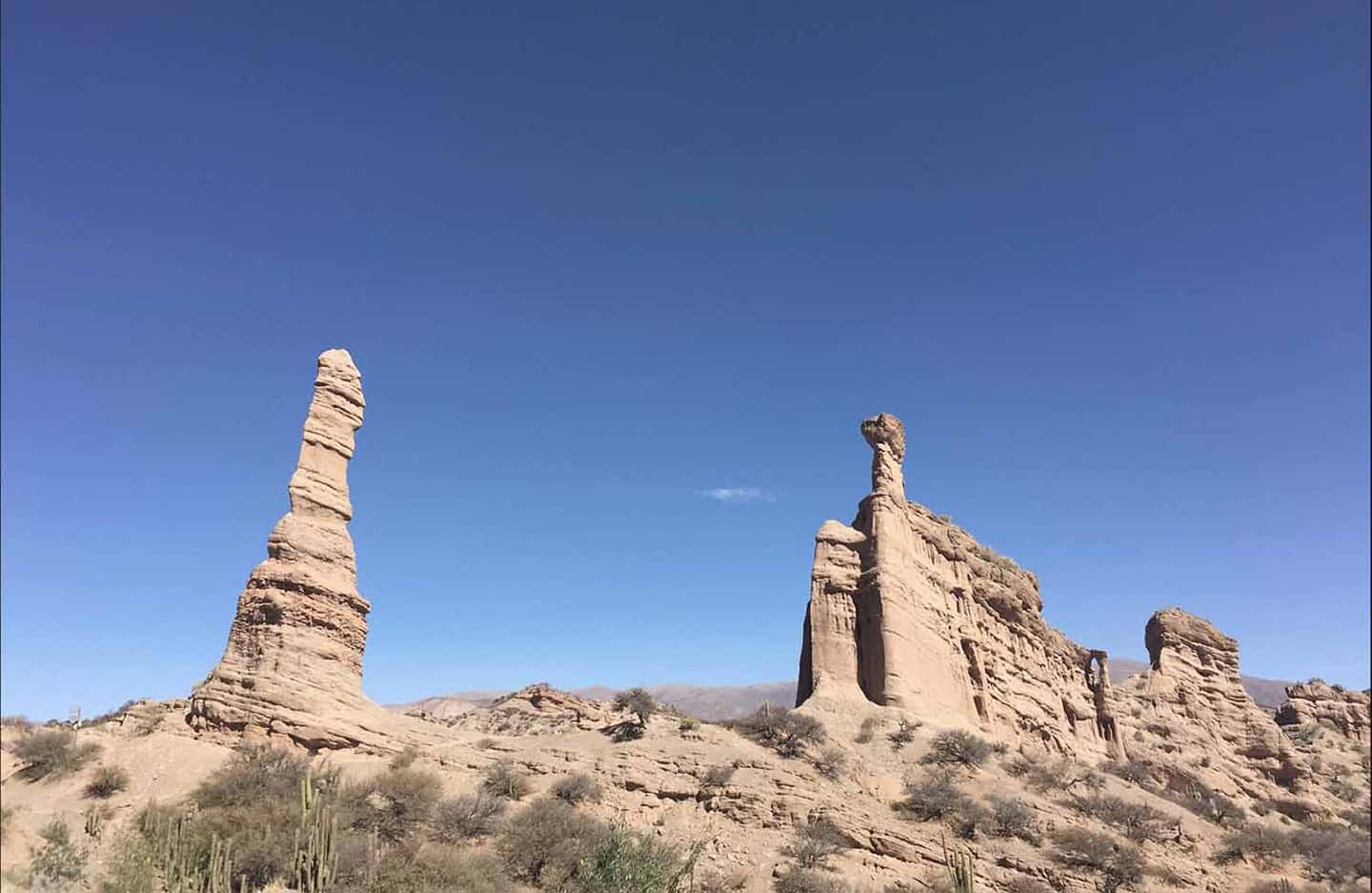 Twin rock pillars rising from the desert floor